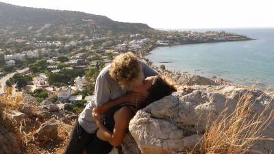 Beautiful Teen Couple In Love Passionately Kissing Above The Sea On Crete Island on vidfreenow.com