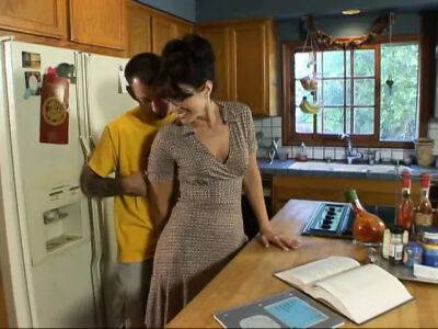 Lusty brunette milf in glasses seduced man next door on her kitchen counter on vidfreenow.com