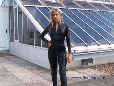 Blonde latex-babes outdoor knee boots and high heels of fetish girl in tight full body rubber outfit with softcore glamour model Karina outside on the roof on vidfreenow.com