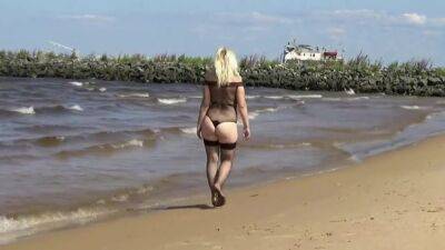 Pretty Woman In A Nylon Bodysuit On The Beach on vidfreenow.com