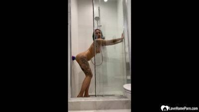 Tattooed teen gril fucking her sex toy in the shower on vidfreenow.com