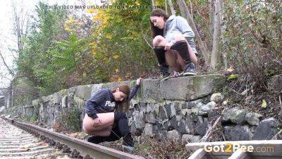 Watch these kinky girls get soaked in pee while getting frisky on the railway on vidfreenow.com